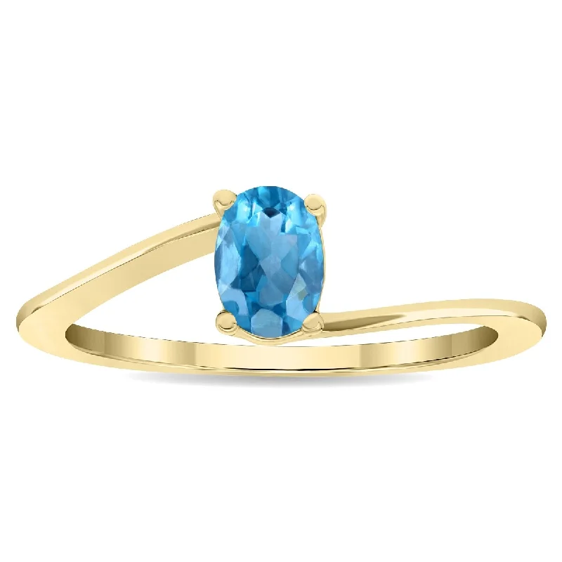 Women's Solitaire Oval Shaped Blue Topaz Wave Ring in 10K Yellow Gold